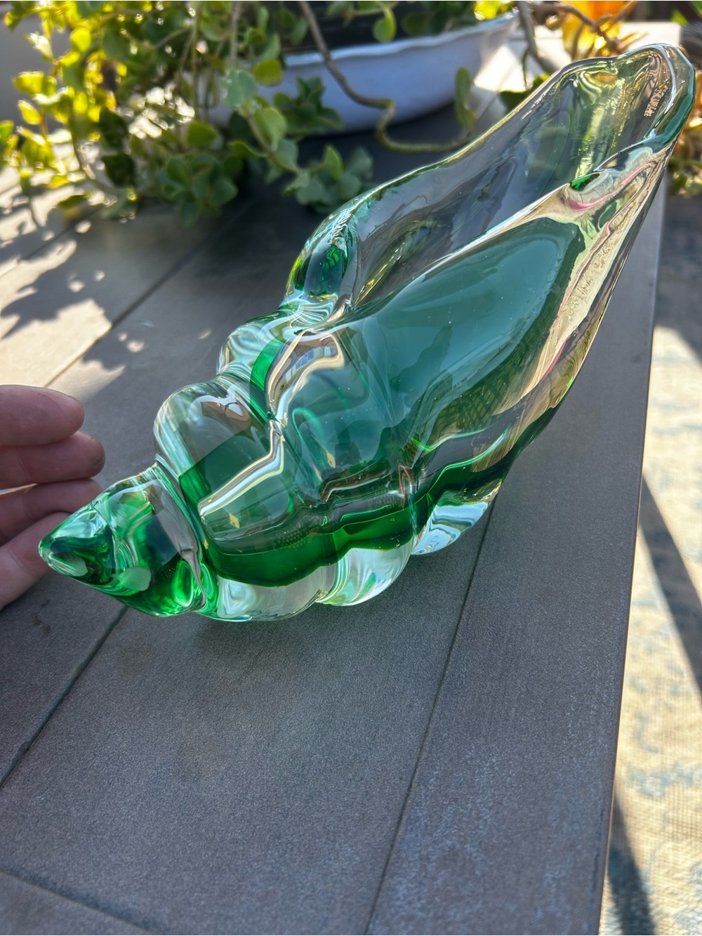 A hand-blown green art glass shell-shaped decorative bowl.